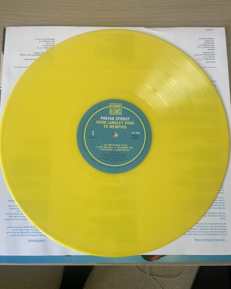 A yellow vinyl record